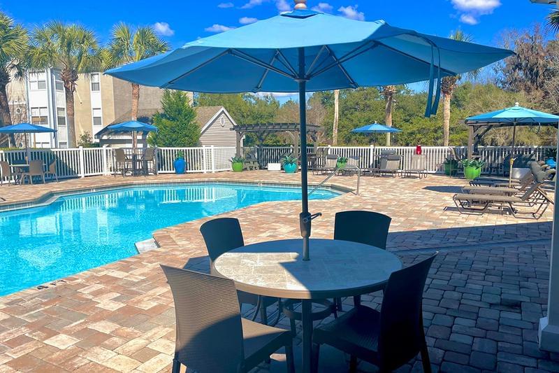 Poolside Tables | Sit by the pool at one of our poolside tables with umbrella.