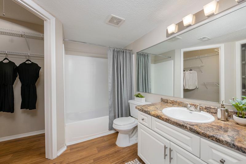 Master Bath | Your master bathroom features an oversized vanity, wood-style flooring, and a spacious walk-in closet.