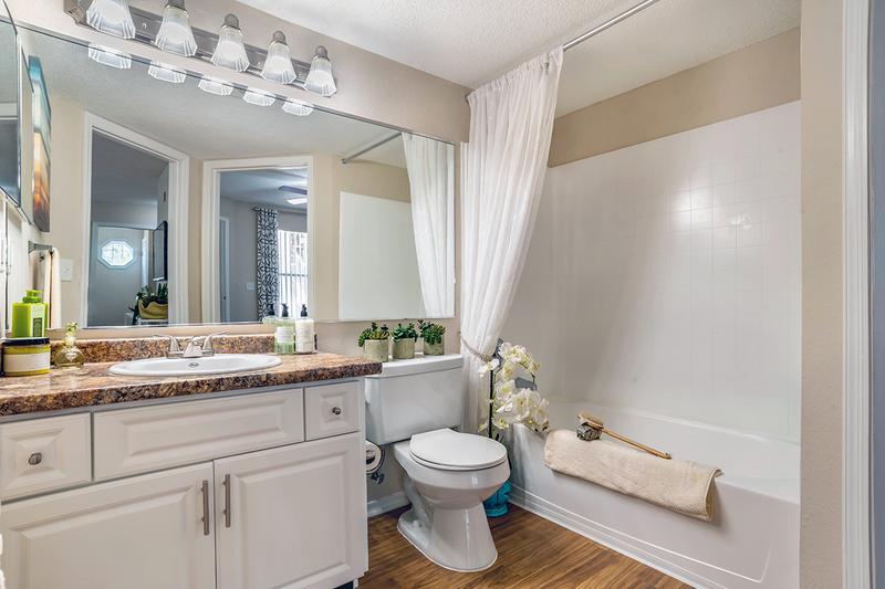 Bathroom | Newly remodeled bathrooms featuring updated counter tops, cabinetry and large mirrors.
