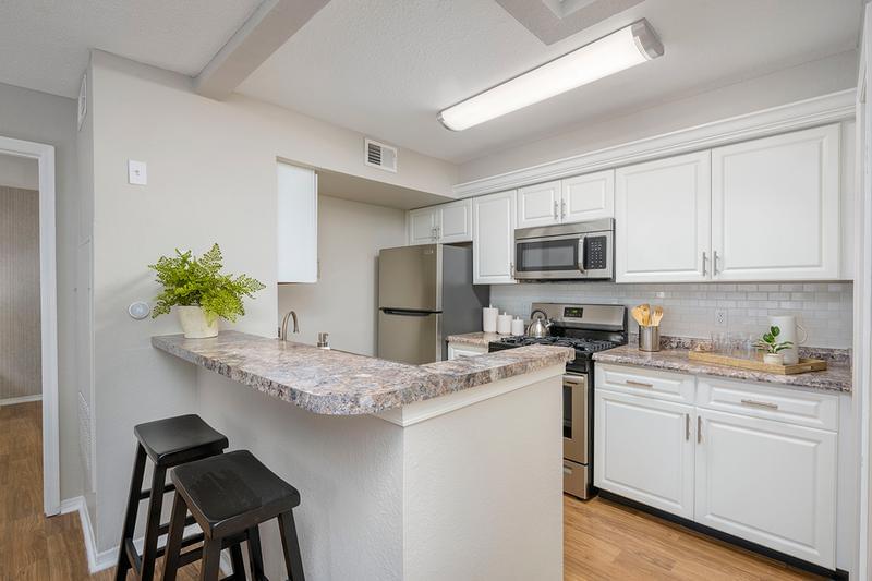 Kitchen | Kitchens featuring stainless steel appliances, granite-style countertops, and a subway tile backsplash.