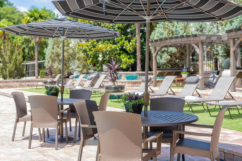 Tables with Umbrellas | Our expansive sundeck features plenty of tables with umbrellas.