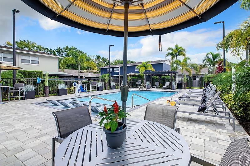 Poolside Seating | Our expansive sundeck includes plenty of poolside seating including tables with umbrellas.
