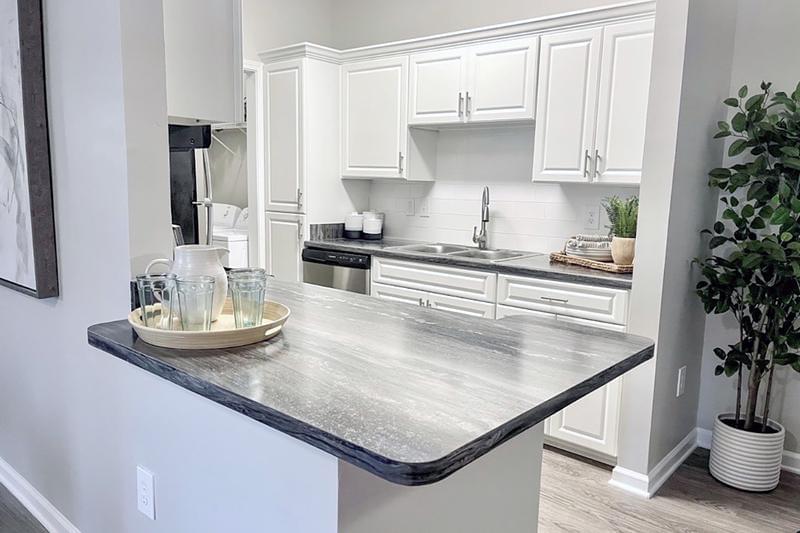 New Cabinetry & Kitchen Islands | The finishing touches including a spacious kitchen island, subway tile backsplash and gooseneck pull-down faucet make this kitchen perfect for everyday use.