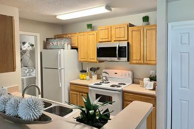 Classic Kitchen | Kitchens featuring a breakfast bar, ample cabinetry, and a laundry room.