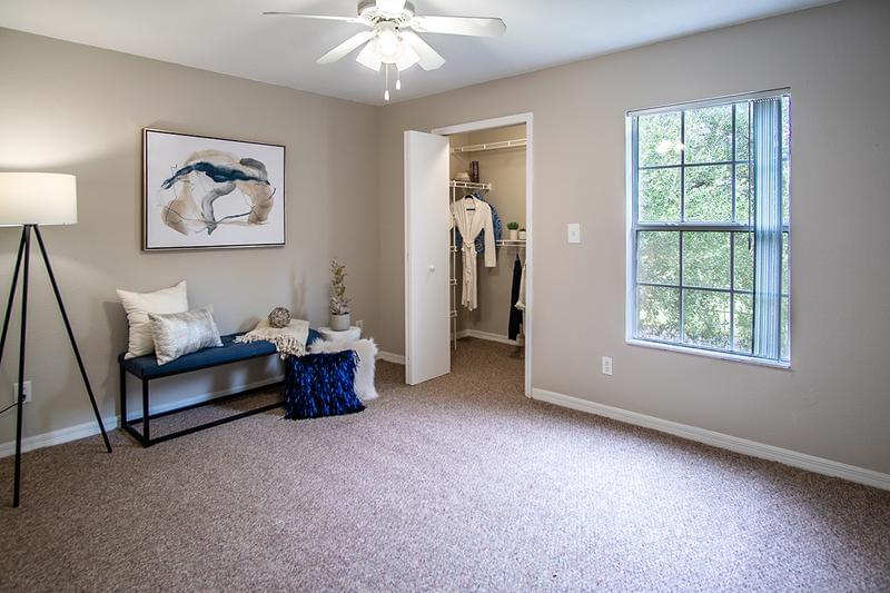 Classic Master Bedroom | Master bedroom featuring a walk-in closet and a multi-speed ceiling fan.