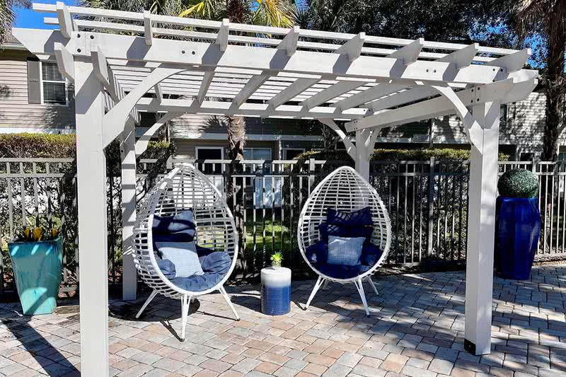 Pool Deck Seating | Relax and get some shade under our poolside pergola.