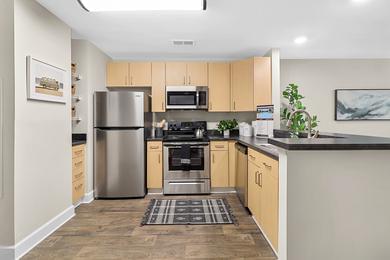 Premier Kitchen | You'll love our newly renovated kitchens featuring a ample cabinetry, stainless steel appliances, and a breakfast bar. 