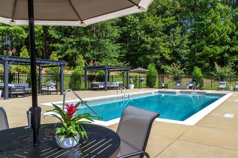 Poolside Tables | Our expansive sundeck features plenty of tables with umbrellas.