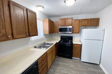 Kitchen | Fully applianced kitchens featuring ample cabinetry.