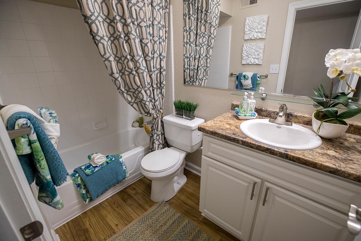 Bathrooms feature updated countertops and cabinetry and large mirrors.