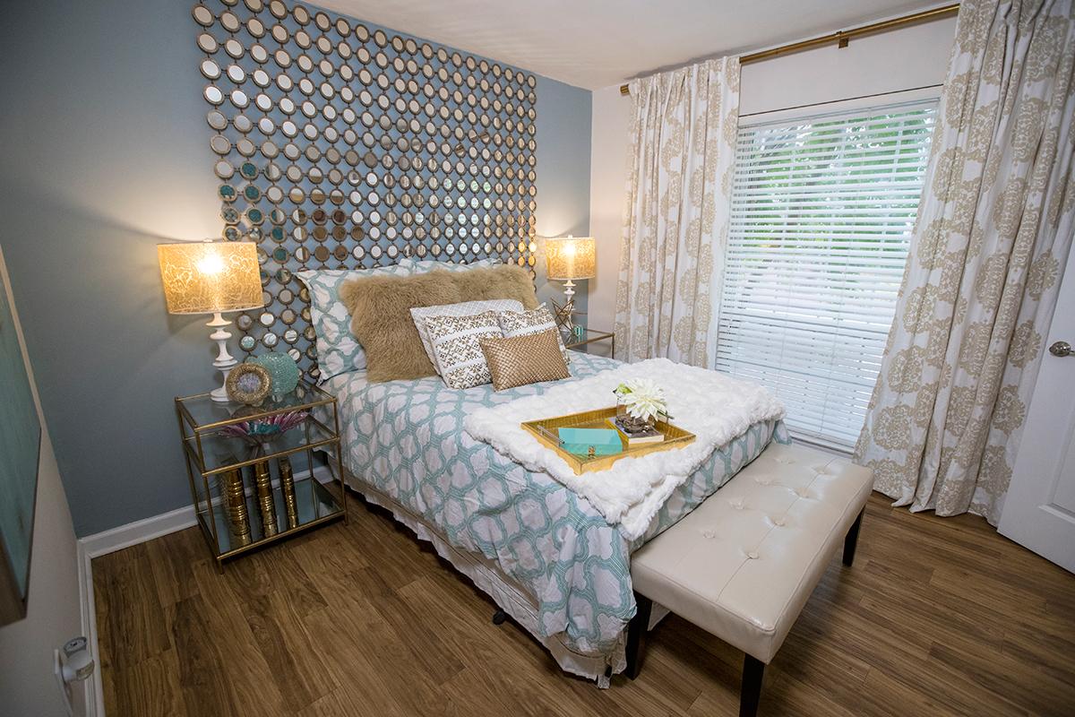 Spacious bedrooms featuring wood-style flooring and large windows.