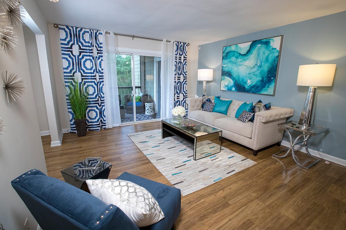 Your spacious living room features wood-style flooring and slider doors that lead to your very own private patio.
