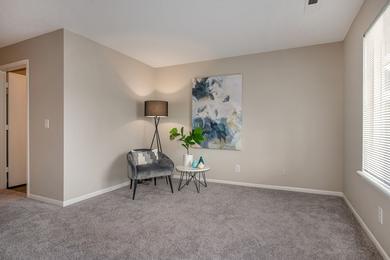 Living Room | Spacious living rooms feature plush carpeting or wood style flooring and a multi-speed ceiling fan.