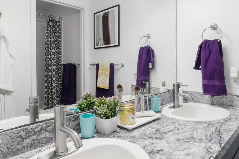 Bathroom | Each spacious bathroom features 2 sinks, marble-style countertops, and brush-nickel features