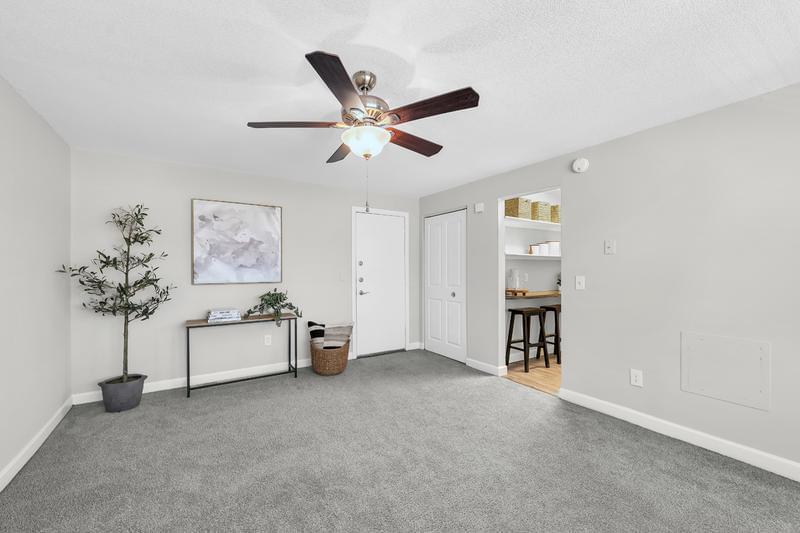 Living Area | Living area features a ceiling fan and plush carpeting in select homes.