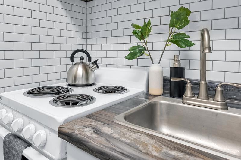 Subway Tile Backsplash | Premium white subway tile backsplash in all kitchens add to the modern look of our premier studios.