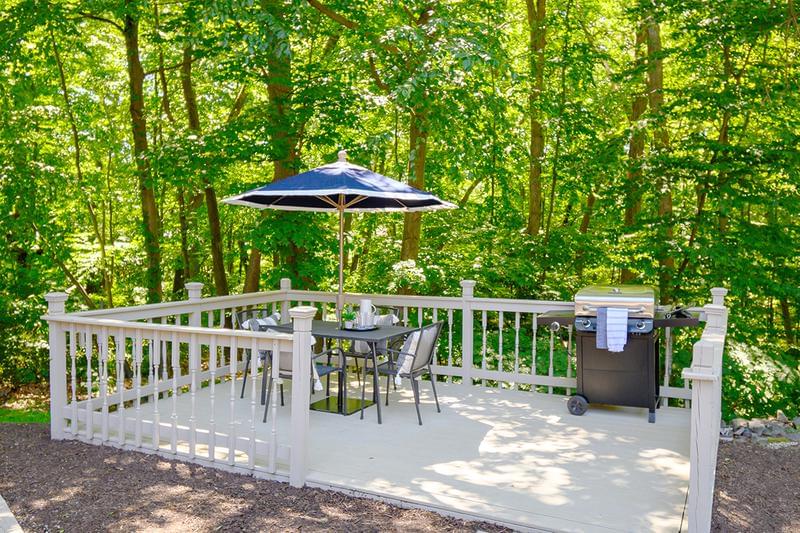 Picnic Deck | Have a cookout on our picnic deck featuring a gas grill and a table with umbrella.