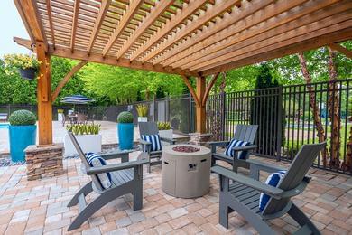 Firepit | Warm up by our poolside firepit located under our pergola.