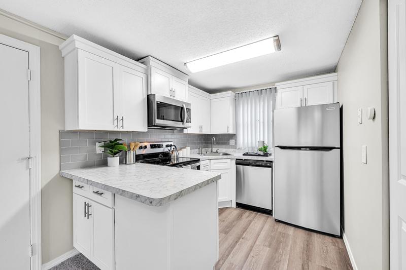 Modern Style Kitchens | Newly renovated kitchens featuring Carrara marble counter tops, wood-style flooring, and stainless-steel appliances.