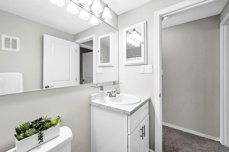 Bathroom | Newly remodeled bathrooms featuring wood-style flooring and marble-style counter tops. 