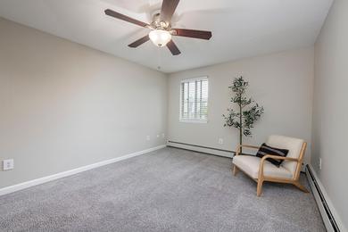 Spacious Bedroom | Spacious bedrooms with plush carpeting and a ceiling fan.