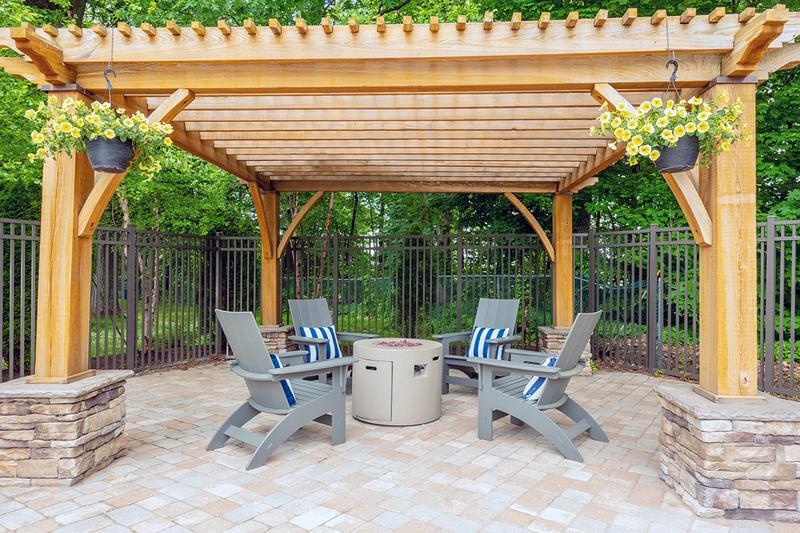 Firepit | Warm up by our poolside firepit under our pergola.