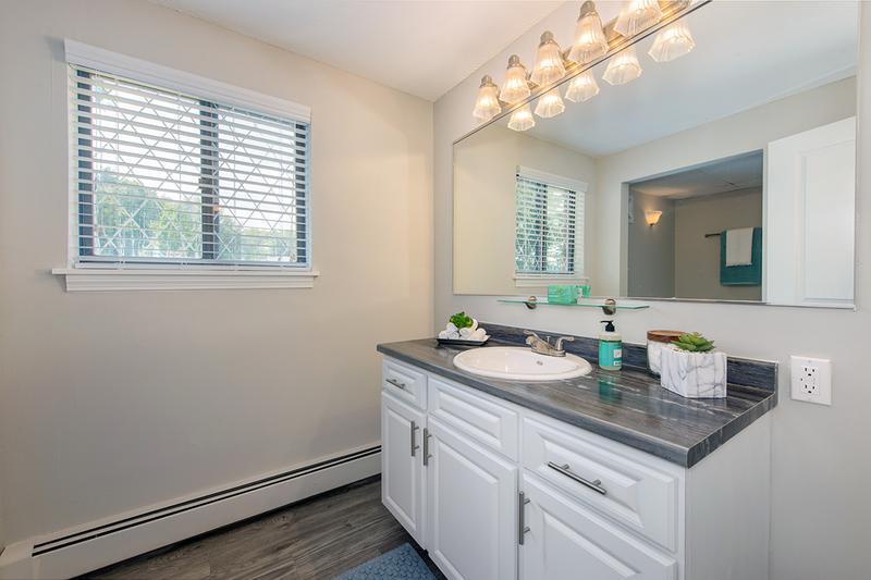 1 Bedroom Bathroom | Bathrooms featuring black fusion counters, and a large mirror.