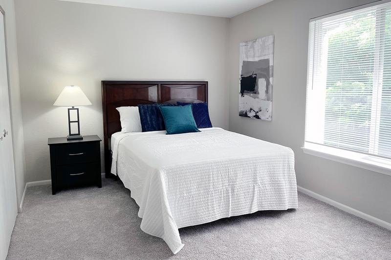 Bedroom | Spacious bedrooms featuring large windows allowing for natural sunlight to shine through.