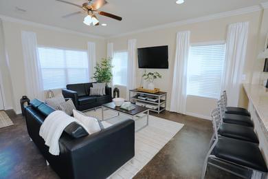 Living | Spacious, open living rooms featuring large windows.