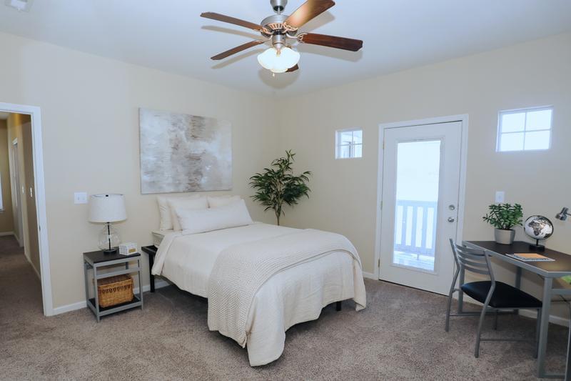 Bedroom | Spacious bedrooms featuring plush carpeting and a multi-speed ceiling fan.
