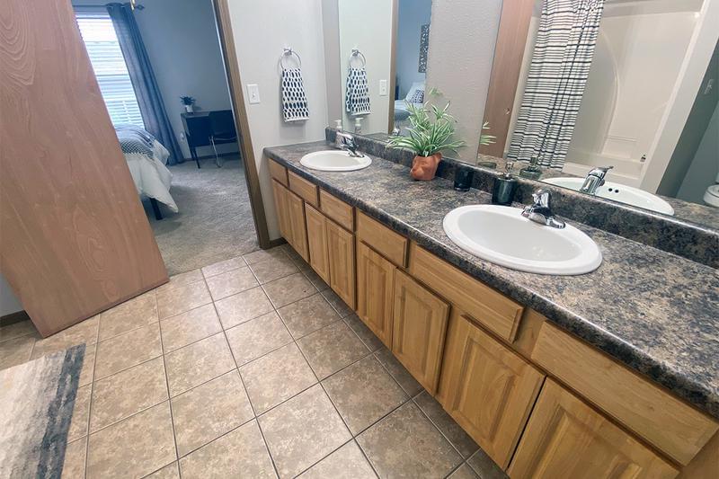 Oversized Bathroom | Bathrooms featuring granite-style countertops, large mirrors and ample cabinetry for your storage needs.