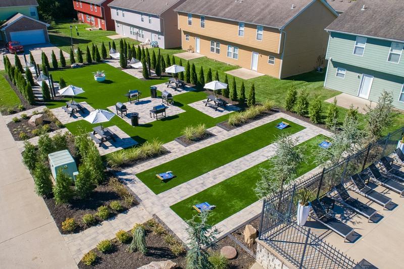 Aerial View of Outdoor Amenities | Enjoy our outdoor amenities featuring cornhole, grilling stations, and a hammock garden.