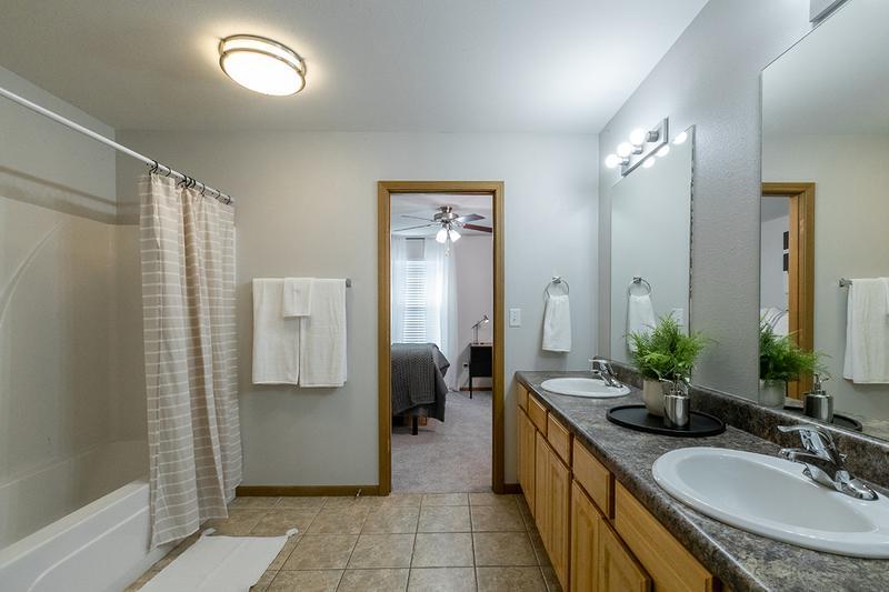 Bathroom | Bathrooms featuring expansive countertops, large mirrors and ample cabinetry for your storage needs.