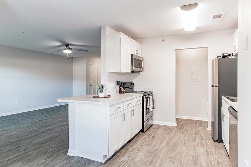 1-Bedroom Kitchen | Our one-bedroom floor plan features a galley-style kitchen featuring granite-style countertops and stainless steel appliances.