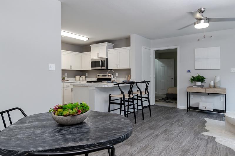 Modern Kitchen | Sleek kitchens featuring wood-style flooring, black fusion countertops, and stainless steel appliances in select homes.