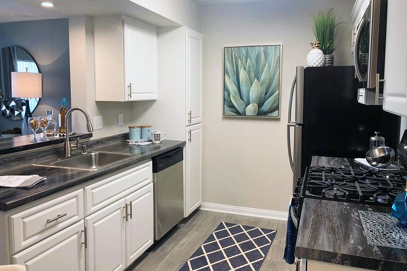 Remodeled Kitchen with Breakfast Bar | Welcome to the kitchen you’ll never want to leave! Each kitchen is equipped with state-of-the-art appliances, which include: stove, dishwasher, mounted microwave, and refrigerator!