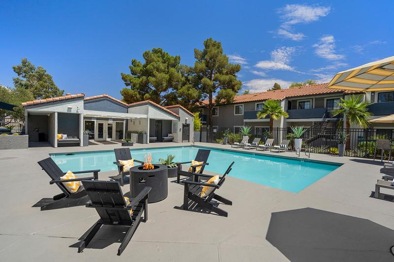 Pool Sundeck with Loungers | Out expansive sundeck features a fireplace, loungers, and tables with umbrellas.