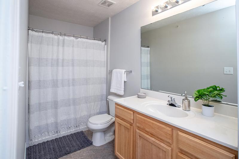 Bathroom | Bathrooms featuring wood-style flooring and large vanities.