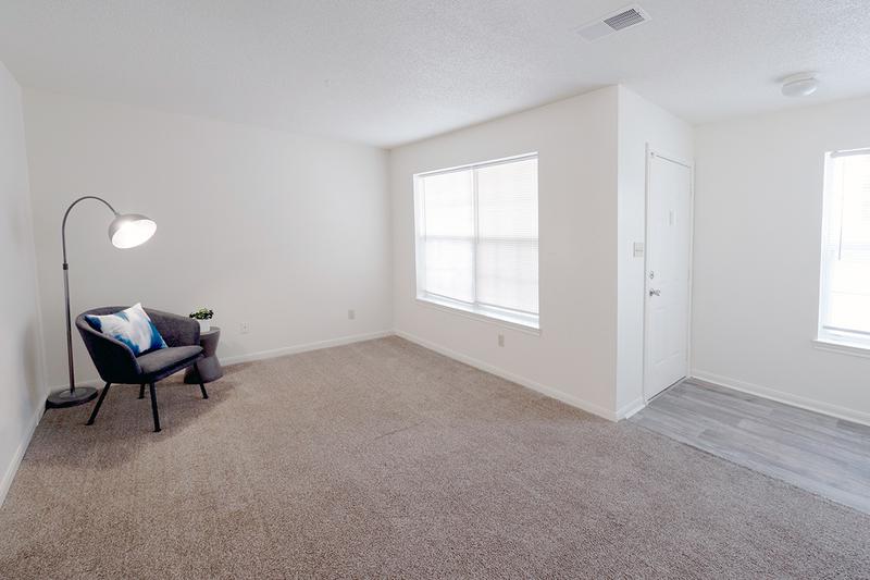 Townhome Living Room | Spacious, open living rooms featuring plush carpeting.