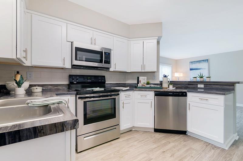 Renovated Kitchens | Open concept kitchens featuring wood-style flooring and breakfast bar.