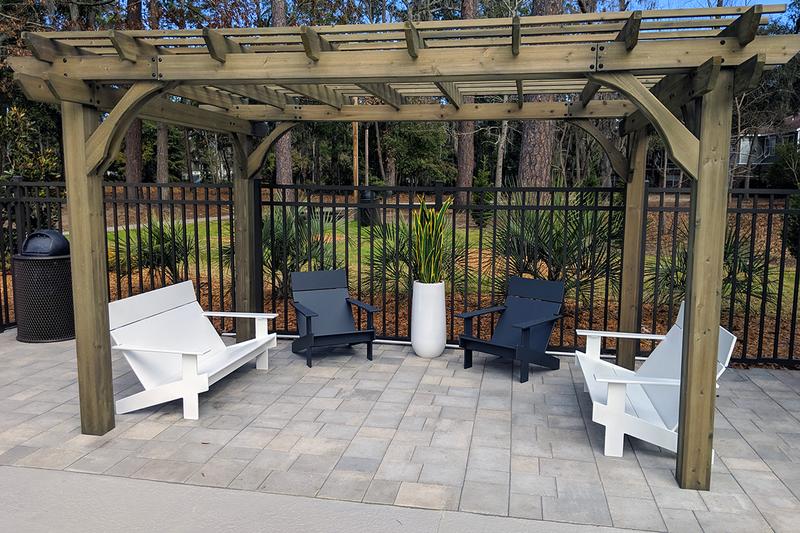 Outdoor Pergola with Benches | Relax and read a book under our poolside pergola.