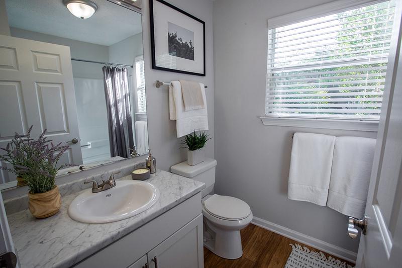 Guest Bathroom | Bathrooms featuring wood-style flooring with large mirrors and vanities.