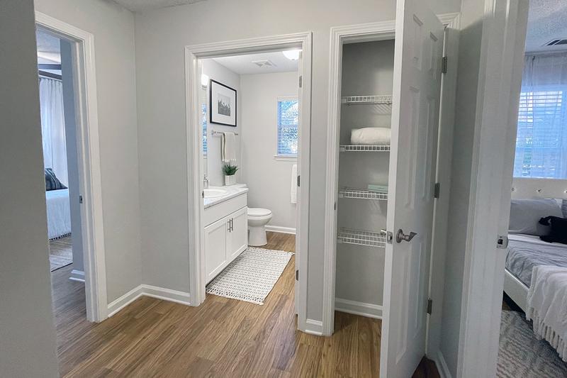 Linen Closet | The hallway features a linen closet with built-in organizers.