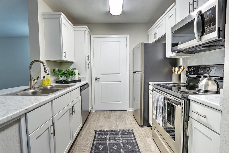 Renovated Kitchens | All of our kitchens have been newly renovated with an abundance of cabinet space, stainless steel appliances and a lowered bar top overlooking your living room.