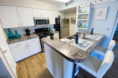 Kitchen | Newly renovated kitchens with wood-style flooring, granite-style counter tops, and full sized pantries.
