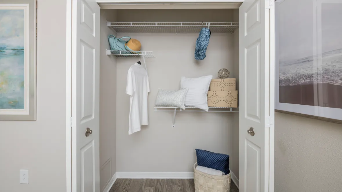 Roomy closet with double bi-fold doors revealing ample open-wire shelving for your wardrobe essentials.