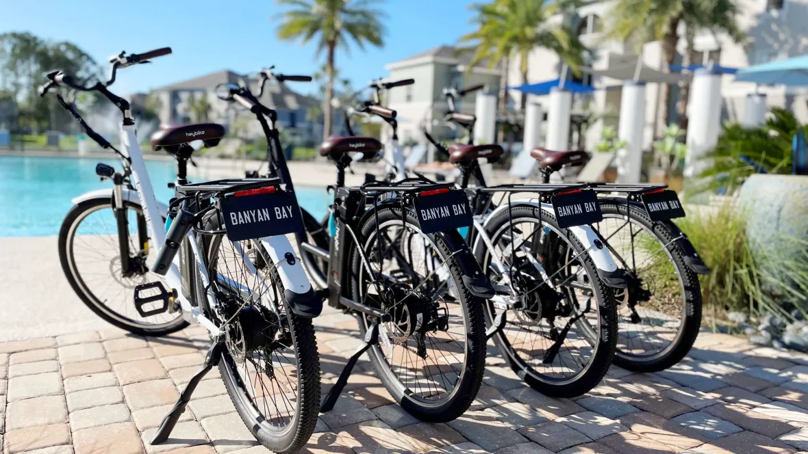A lineup of electric bikes with 'Banyan Bay' tags, ready for thrilling rides through the sunny streets of Jacksonville.