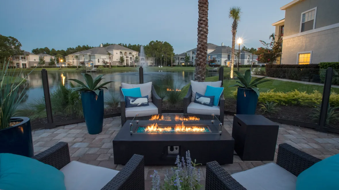 A tranquil evening by the fire pit with a view of the serene water.