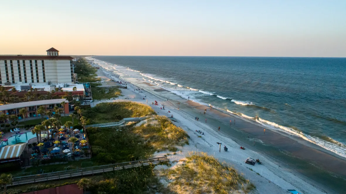 A captivating aerial view of Jacksonville Beach, with its bustling boardwalk, pristine coastline, and sparkling ocean waters. This vibrant beach community offers residents the ultimate coastal escape.