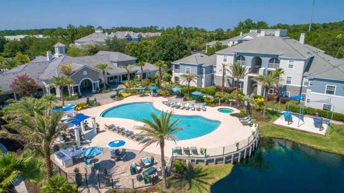 An aerial view of the vibrant, tropical atmosphere, resort-style amenities, and beautifully maintained community.   